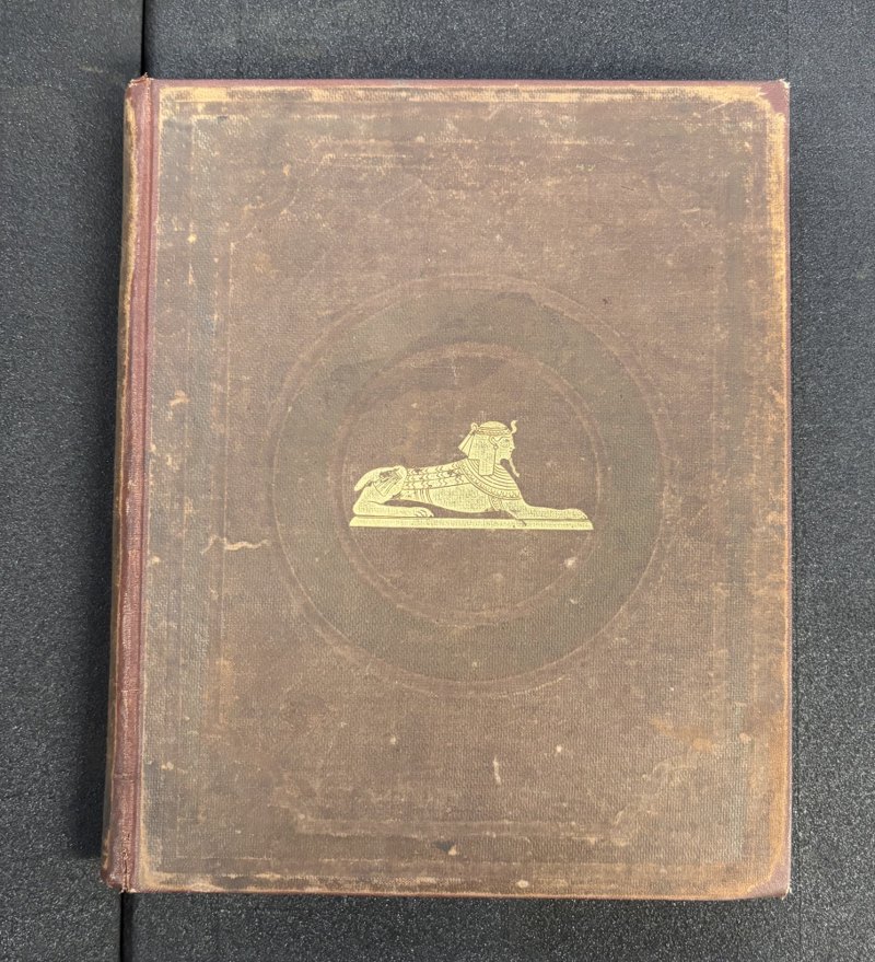 George Hunt copy: original brown publisher’s cloth front board with gilt sphinx