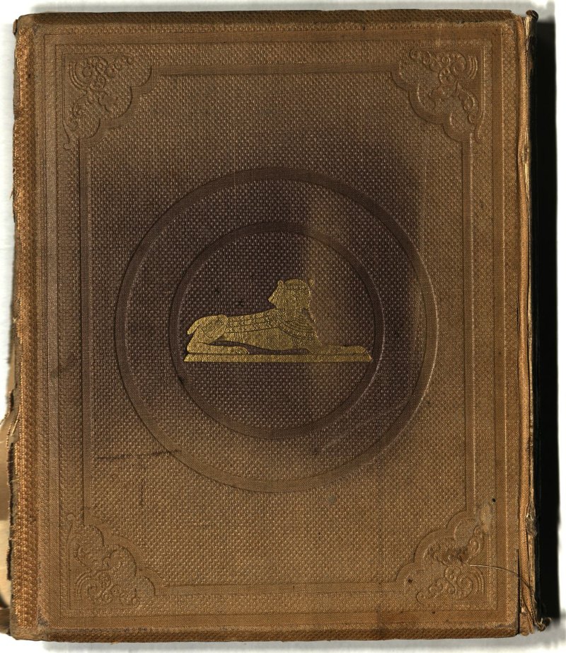 Brown rear board with gilt sphinx and stamped decoration
