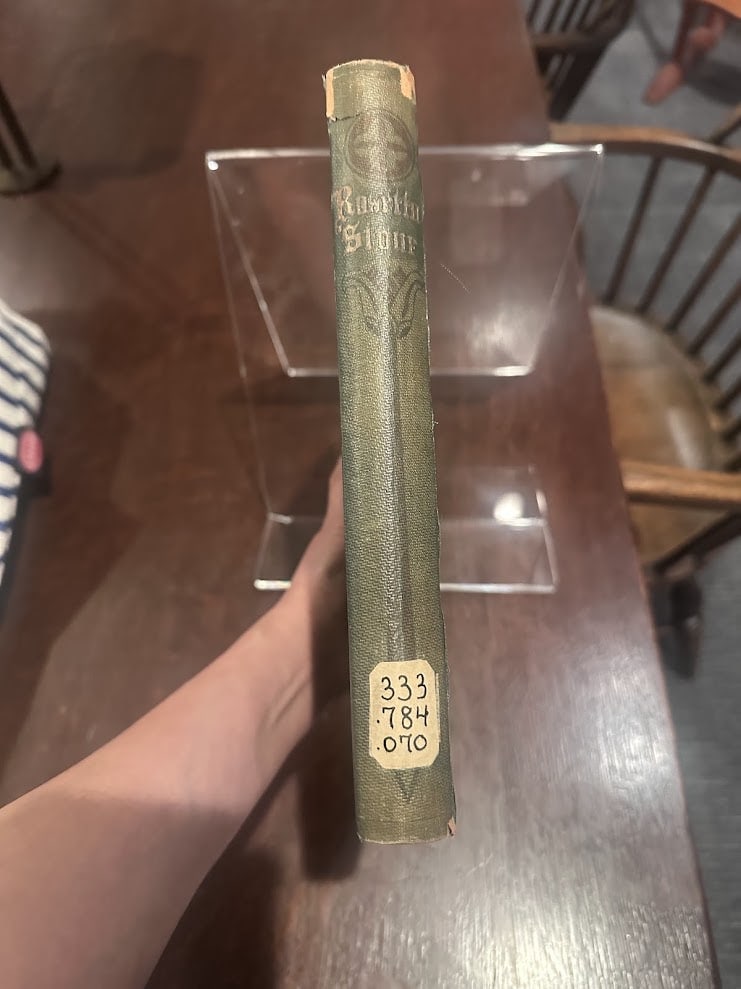 Original green cloth spine with lettering, stamped ornaments, and call-number label