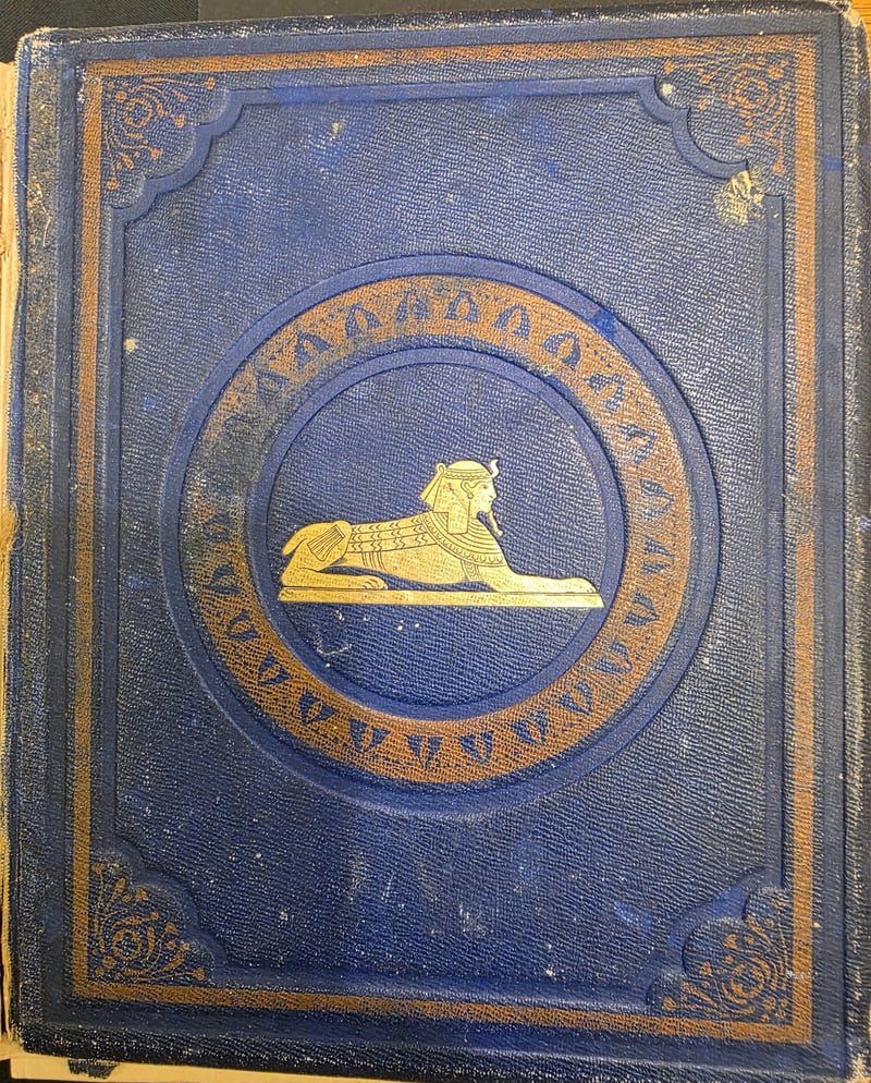 Original blue cloth front cover with gilt sphinx in a roundel, stamped lotus band, borders, and corner ornaments