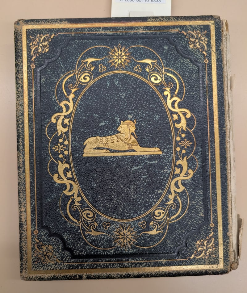Black Extra-Gilt rear board with the same gilt design; barcode slip partly visible
