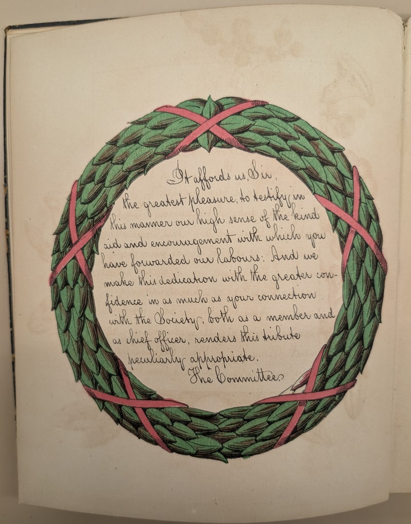 Text leaf within a green wreath