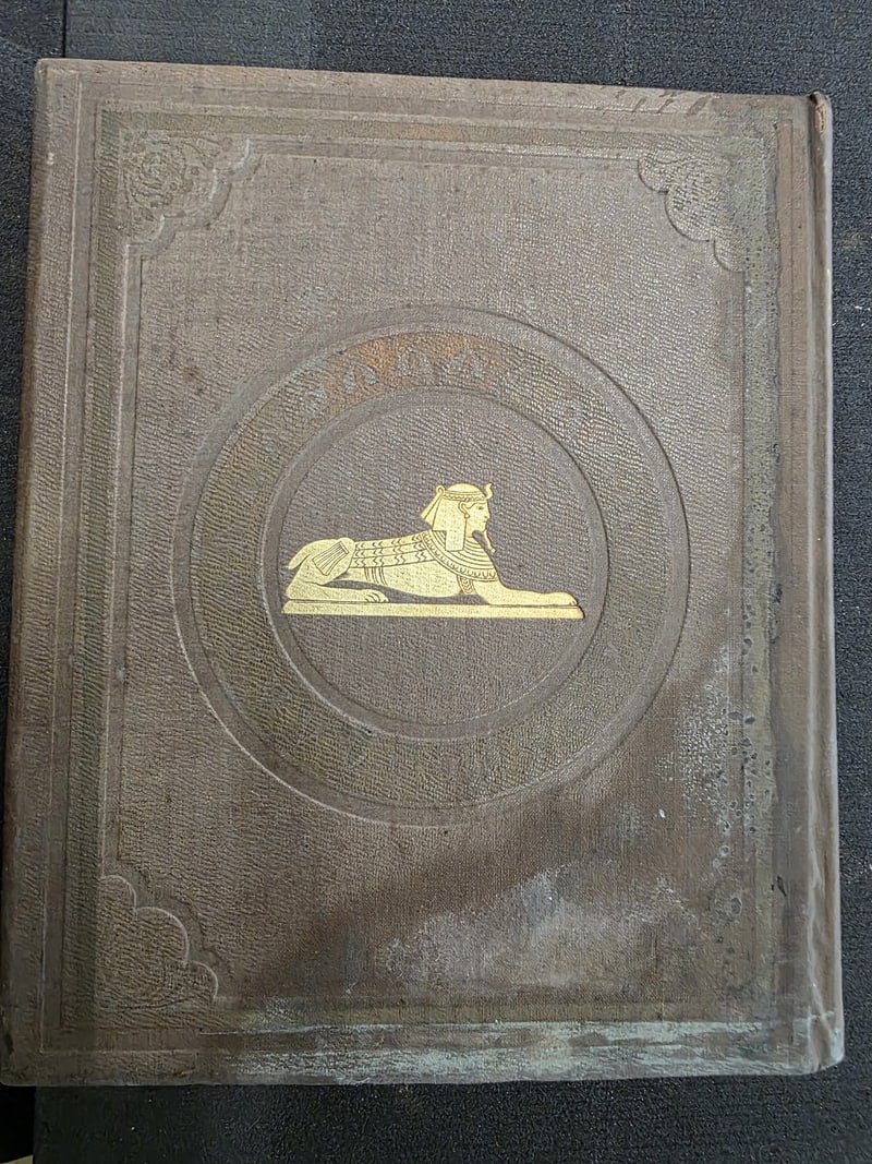 Brown cloth rear board with gilt sphinx