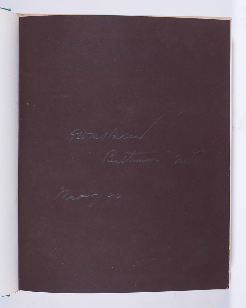 Dark brown endpaper with faint pencil inscriptions